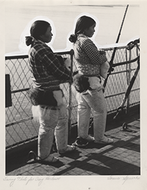 "Leaving Thule for Craig Harbour" [Two Thule women  aboard the "Nascopie" holding husky puppies.], photograph by Lorene  Squire. 1938. 
